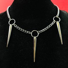 Punk Rock Triple Spikes Necklace Choker O Ring Necklace O-Ring Thorns Pendants On Silver Color Curb Chain Necklace Choker. Approximate Length 18” Width 5mm. Material: Steel Chain, Silver Or Stainless Steel Color Plated Alloy Spikes And Oring , Spikes Punk Length: 2” Spikes Are Hollow Light Weight O-Ring Diameter: 15mm Please Be Aware That The Items Have Spikes. Please Be Cautious And Be Careful In Using Them. By Purchasing The Items, You Are Aware And Take Your Own Risk Of Anything Involved In U Rock Style Jewelry Choker For Alternative Fashion, Rock Style Choker Jewelry For Alternative Fashion, Rock Style Choker For Alternative Fashion, Punk Style Jewelry With Adjustable Chain For Gifts, Punk Choker Necklace For Concerts, Punk Gold Stainless Steel Jewelry, Punk Jewelry With Adjustable Stainless Steel Chain, Punk Style Necklace With Adjustable Chain For Streetwear, Punk Style Stainless Steel Jewelry With Adjustable Chain