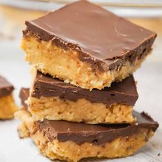 three pieces of chocolate peanut butter bars stacked on top of each other