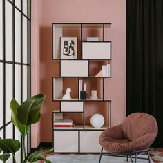 a chair sitting in front of a book shelf