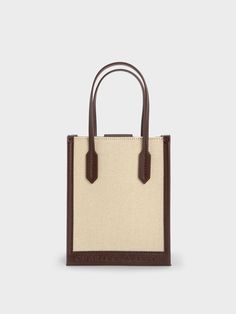 Cool and utterly chic, this geometric canvas tote bag is the perfect piece to complete any casual ensemble. Featuring a classic rectangular silhouette, a versatile cream-and-brown colourway, and lightweight canvas construction, this bag will slot seamlessly into your wardrobe rotation. Carry yours by the elongated double handles, or simply clip on the detachable strap and turn it into a crossbody bag for hands-free convenience. Eyewear Chain, Brand Collaboration, Consumer Protection, Charles Keith, Brown Canvas, Canvas Tote Bag, Hands Free, Canvas Tote, Clip On