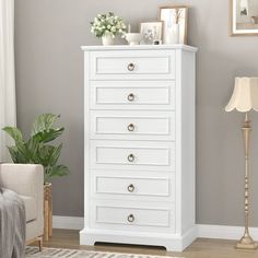 a white chest of drawers in a living room