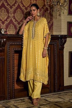 Yellow kaftan with mirror embroidery. Paired with a pant. - Aza Fashions Unstitched Kaftan With Mirror Work For Navratri, Bollywood Style Kaftan With Mirror Work For Navratri, Anarkali Kaftan With Mirror Work For Festivals, Traditional Drape Pant Set With Gota Work For Eid, Eid Pant Set With Gota Work And Traditional Drape, Festive Traditional Pant Set With Mirror Work, Eid Traditional Drape Pant Set With Gota Work, Eid Gota Work Pant Set With Traditional Drape, Traditional Pant Set With Gota Work And Drape