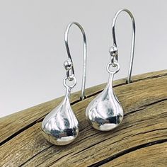 Delicate sterling silver puffed teardrop shines from sterling silver earring wires. Teardrop measures approximately 16mm x 8mm Classic Silver Drop Earrings For Pierced Ears, Silver Teardrop Earrings With Polished Finish, Classic Sterling Silver Teardrop Earrings, Silver Teardrop Earrings With Polished Finish For Gift, Formal Sterling Silver Teardrop Earrings With Polished Finish, Formal Sterling Silver Teardrop Earrings, Classic Silver Teardrop Earrings, Classic Silver Teardrop Pendant, Classic Silver Teardrop Earrings Gift