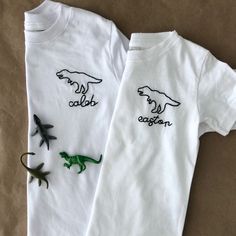 The sweetest hand embroider tee for the little Dino lover in your life. Shirt Details: 100% combed ring spun cotton fine jersey Please size up if you are in between sizes as shirts will shrink after wash/dry Size chart in images to reference Any questions - please message me. Returns and Exchanges: I do not accept returns on personalized pieces but will be happy to discuss any issues via messages. Thanks for visiting Sweet Olive Street! Check us out on Instagram for more behind the scenes - @swe Cute T-shirt With Machine Embroidery And Short Sleeves, Cute White T-shirt With Machine Embroidery, Cute Machine Embroidered Short Sleeve T-shirt, White Family Matching T-shirt With Embroidered Text, Family Matching White T-shirt With Embroidered Text, White Embroidered T-shirt For Family Matching, Cute White T-shirt With Custom Embroidery, White Cute T-shirt With Custom Embroidery, Cute Cotton Tops With Machine Embroidery