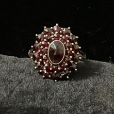 This is a beautiful antique garnet cluster ring set in 900 silver. The ring has a tiered design, and the top tier does wiggle some, though it is likely not at risk of coming off. Overall, the piece is in very great shape and was likely made in the late-1800s or early-1900s. Size US 5.5 Top Dimensions: 0.75in x 0.6in Vintage Red Garnet Cluster Ring, Vintage Garnet Cluster Ring As Gift, Antique Cluster Ring As A Gift, Vintage Ruby Cluster Ring For Formal Occasions, Vintage Ruby Cluster Ring For Formal Events, Heirloom Oval Garnet Cluster Ring, Antique Multi-stone Cluster Jewelry, Vintage Multi-stone Ruby Cluster Ring, Vintage Ruby Multi-stone Cluster Ring