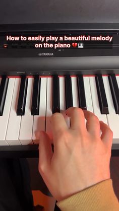 someone is playing the piano with their hand on it's keyboard, which reads how to easily play a beautiful melody on the piano