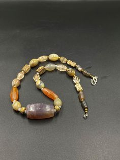 The beautiful ancient agate beads necklace from ancient Himalayan civilization culture The age of this beads are more than 1000 years old The necklace consist of Agate ,carnelian and crystals and white stone the crystals looks so shinny looks like recently buffed some gold wax beads and brass beads are used as spacers in the necklace we provide fast and free shipping service Amber Beaded Necklaces With Natural Stones For Healing, Spiritual Amber Beaded Necklaces With Natural Stones, Spiritual Amber Beaded Necklace With Natural Stones, Amulet Style Crystal Necklace With Gemstone Beads, Spiritual Amber Beaded Necklaces With Stones, Spiritual Amber Beaded Necklace With Stones, Vintage Necklace With Round Gemstone Beads, Gift Jewelry With Natural Stones In Vintage Style, Amber Agate Gemstone Beads Crystal Necklaces