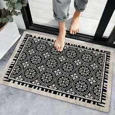 a person standing on top of a door mat