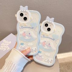 someone holding two cell phones in their hands with the same phone case on top of them