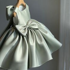 a dress made out of satin material with a bow