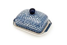 a blue and white dish with a lid on the bottom, sitting on a white surface