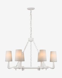 a white chandelier with four lamps hanging from it