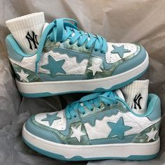 a pair of sneakers with blue and white stars on the upper part of each shoe