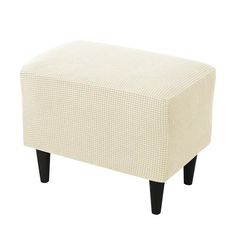 a white ottoman with black legs on a white background