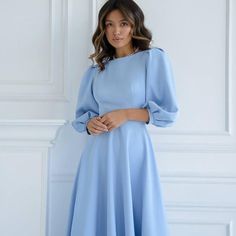 Embrace elegance with this blue midi dress, featuring romantic puff sleeves and a stylish back cutout. The open-back design and delicate button details add a modern twist to this timeless silhouette. Perfect for weddings, parties, or any special occasion, this dress combines chic sophistication with a playful touch. 💖 Puff sleeves for a romantic, feminine look 💖 Chic back cutout with delicate button detailing 💖 Midi length for a refined and elegant silhouette 💖 Tie-back waist for a flatterin Elegant A-line Puff Sleeve Dress In Solid Color, Elegant Spring Backless Dress In Solid Color, Elegant Solid Color Backless Dress For Spring, Formal Midi Dress With Structured Puff Sleeves, Formal Midi Dress With Puff Sleeve And Structured Shoulders, Elegant Midi Dress For Brunch, Midi-length Puff Sleeve Dress With Structured Shoulders For Parties, Puff Sleeve Midi Dress With Structured Shoulders For Party, Knee-length Midi Dress With Gathered Sleeves For Evening