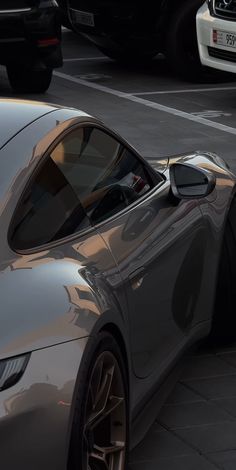 a silver sports car parked on the side of the road