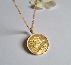 This gold coin necklace was handmade using an old gold Moroccan coin an acquainted of mine inherited from her mother.  The pendant can be used on both sides. See last photo for the back side of the coin. The necklace is a quality 14k gold filled chain. The coin pendant necklace is also available in sterling silver. Dimensions: The old Moroccan coin pendant's diameter is 2.1 cm (0.8 inches) The 14k gold necklace is available in multiple lengths.  This Gold coin necklace is delicate, unique and be Brass Coin Necklace Gift, Brass Coin Necklace For Gift, Gold-plated Coin Necklace For A Gift, Handmade Gold Coin Necklace With Round Pendant, Gold Round Coin Necklace For Anniversary, Vintage Yellow Gold Brass Coin Necklace, Gold Plated Coin Necklace For Gifting, Yellow Gold Coin Necklace For Anniversary, Gold Coin Necklaces With Vintage Charm