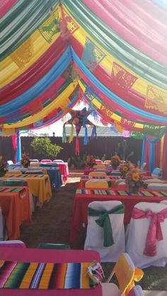 an outdoor event with colorful tables and chairs