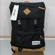 Eastpak Rowlo Backpack In Black - Black / No Size Eastpak Backpack Aesthetic, Rectangular Black Backpack For On-the-go, Eastpak Backpack Black, Eastpak Backpack, Black Versatile Backpack With Anti-theft Pocket, Commuter Backpack, Black Travel Backpack With Anti-theft Pocket, Hiking Bag, Blue Backpack