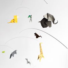 an origami giraffe and other animals are flying in the sky together