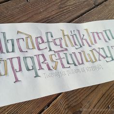 the upper and lower letters are drawn with colored crayon pencils on paper