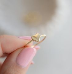 Beautiful, and dainty heart ring.  Great for stacking or as a gift!  - - - D E T A I L S - - -  * Made of 925 Sterling Silver * Available in 14k Gold or Rhodium Plated * We use a THICK plating of 14k Gold for a piece that is sure to last years to come * Nickel-free & Hypoallergenic * WILL NOT TURN FINGER GREEN!  * Available in Sizes 4, 5, 6, 7, 8, 9, or 10 * Ring Measurements:      Heart: 7mm     WIDTH: 1.3mm Ring Sizer- https://www.etsy.com/listing/1240904225/ring-sizer-reusable-ring-sizer-plastic?click_key=b5e074cfb419bcfddc2d9f2ce4b2f5376e4b8de0%3A1240904225&click_sum=ac940e75&ga_search_query=ring%2Bsizer&ref=shop_items_search_2&pro=1 Stacking Rings Shown on Model: https://www.etsy.com/listing/739952471/dainty-diamond-stacking-eternity-ring?ref=shop_home_active_8&pro=1 https://www.etsy. Heart Ring Gold, Gold Heart Ring, Silver Heart Ring, Zierlicher Ring, Promise Ring Gift, Braided Ring, Ring Stacking, Rose Gold Band, Platinum Metal