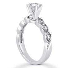 a white gold engagement ring with two diamonds on the side