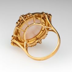 This striking cocktail ring is centered with one (1), bead set, round cultured mabe' pearl and is bordered with twelve (12), prong set, round brilliant cut diamonds. The ring measures 26.7mm at the top, rises 11.9mm above the finger, tapering to 2.6mm wide and 0.9mm thick at the base of the shank. This ring is currently a size 7.25. This ring has a lovely gentle patina. Pearl Cocktail Ring, Mabe Pearl, Bead Set, Amethyst Jewelry, February Birth Stone, Round Brilliant Cut Diamond, Cocktail Ring, High Quality Jewelry, Brilliant Cut Diamond