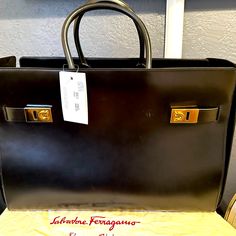 Salvatore Ferragamo Handbag, Can Be Used As A Weekender Bag. Elegant Black Briefcase With Dust Bag, Designer Leather Briefcase For Evening, Elegant Business Bag With Branded Hardware, Elegant Business Bags With Branded Hardware, Designer Rectangular Calf Leather Bags, Designer Briefcase With Branded Hardware, Designer Business Bags In Calf Leather, Luxury Formal Bags With Branded Hardware, Designer Rectangular Briefcase With Branded Hardware