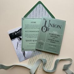 the wedding stationery is laid out on top of each other, including an envelope and ribbon