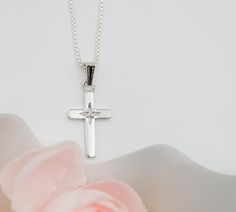 From our "Timeless Collection" this cross pendant necklace is a beautiful keepsake piece featuring a tiny sparkling diamond that's just perfect for a First Communion, Confirmation, Christening, or Baptism gift.   🌸This piece is rhodium-plated to prevent tarnish for everlasting quality 🌸High-end Italian chain with durable lobster clasp is available in two lengths: 14" or 16-18" adjustable. (see sizing chart in photos) 🌸This necklace comes in our Timeless Collection gift box!  🌸PERSONALIZE IT! Silver Cross Jewelry For Confirmation, Sterling Silver Cross Necklace For First Communion, Sterling Silver Cross Pendant Necklace For First Communion, White Gold Cross Pendant For First Communion, White Gold Cross Pendant Necklace For First Communion, White Gold Cross Necklace For First Communion, Silver Cross Necklace For Confirmation, Silver Crucifix Necklace For Baptism, White Cross Pendant Necklace For Baptism