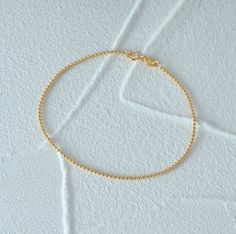 Enhance your elegance with our 925 Sterling Silver Gold Beaded Bracelet, a stunning minimalist piece designed for women who appreciate dainty jewelry. This elegant bracelet features high-quality gold beads meticulously crafted to create a timeless accessory perfect for everyday wear. Whether you're dressing up for a special occasion or adding a touch of sophistication to your daily outfit, this bracelet is the ideal choice. Its lightweight design ensures comfort, while the secure clasp provides Minimalist Hypoallergenic Beaded Round Bracelets, Minimalist Hypoallergenic Round Beaded Bracelets, Minimalist Hypoallergenic Beaded Bracelet, Minimalist Adjustable Sterling Silver Bracelet With Box Chain, Minimalist Sterling Silver Box Chain Bracelet Gift, Minimalist Sterling Silver Adjustable Box Chain Bracelet, Minimalist Hypoallergenic Round Bead Bracelets, Minimalist Bracelets With Tiny Beads, Minimalist Beaded Bracelets With Delicate Chain