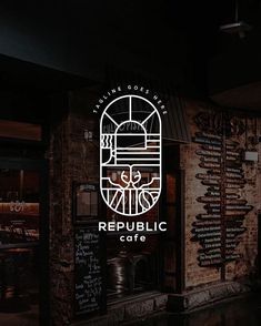 the sign for republic cafe is lit up at night