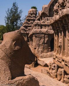 an elephant statue in the middle of a stone building with carvings on it's sides