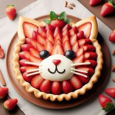 a cake with strawberries in the shape of a cat