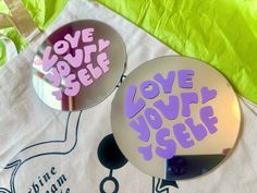 two round mirrors with the words love you self on them