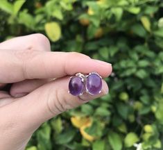 ✨ Read to the end before you order ✨ Treat someone to a very special gift with these amethyst earrings... What you're getting with this order is two smaller-sized, 10x8mm, 100% natural purple amethyst cabochons set in two real, oval-shaped sterling silver earring settings with 4 low prongs. Look at all pictures so you get a good feel for the earrings. Associated with the month of February by the Romans, amethyst has been an incredibly popular stone throughout the ages. Today, those in the metaph Amethyst Earrings Studs, Amethyst Birthstone, Amethyst Studs, Raw Crystal Necklace, The Romans, Birthstone Earrings, Earring Studs, Tiny Stud Earrings, Birthstone Earring