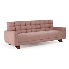 a pink couch sitting on top of a white floor