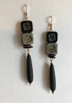 EARRINGS:  Black and grey sophistication in square Czech Picasso  high quality beads known for their vibrant colors!  Even this grey commands respect!  Black matte teardrop beads in a saturated endless black.  Earring wires are 14k gold filled (filled is 100 times thicker than plated!). Handmade Black Contemporary Earrings, Black Rectangular Beaded Jewelry, Contemporary Handmade Black Earrings, Grey Earrings, Black Earring, Gray Earrings, Earring Wires, Teardrop Beads, Scottsdale Az