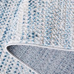 the corner of a blue and white rug