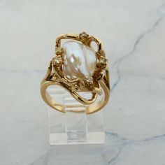 14K Yellow Gold Pearl and Diamond Ring, interesting asymmetrical design, Ring size 6.5, 8.7 grams Stock # R00070 This listing contains photographs of the actual item you will receive.  Our items are in excellent condition with little or no signs of wear and many are one of a kind pre-owned estate finds.   Please look closely at the pictures in this listing as they are part of the product description. Please read the description, as any imperfections or condition comments will be included.  We do our best to accurately describe the condition of each piece and encourage you to ask questions prior to purchase.    We are happy to address any questions you may have.  Please contact us.  Our Store has many other items for sale.  We specialize in fine & designer jewelry, watches & more.    Coloni Pearls Rings Design, Vintage Stone Wedding Rings, 3 Tier Wedding Ring, Diamond Gemstone Ring, Art Nouveau Engagement Ring Antique, Vintage Italian Engagement Rings, Antique Engagement Rings Vintage 1920s Gold, Opal Ring Stack, Engagement Rings Untraditional