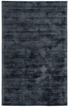 an area rug with dark gray colors