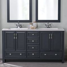 two mirrors are above the double sink vanity in this bathroom with gray cabinets and white countertops