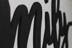 a close up view of the name of a wall with black and white lettering on it