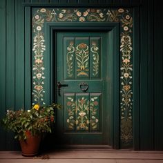 a potted plant sitting in front of a green door with floral designs on it