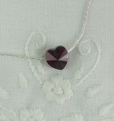 "♥'¨) ¸.*' ¸.**'. (¸.*' (¸.A petite 8mm Siam ruby Swarovski crystal heart rests sweetly on a sterling silver beading chain. This delicate 16\" necklace is closed with a sterling silver lobster claw or spring ring clasp. Simple yet stunning, this would be a perfect gift for a lucky girl. If you need a different chain length, at no additional charge, (up to 20\") just convo me or leave a note in the message to seller. This necklace is also available in gold finish upon request. I can make this nec Ruby Heart Necklace, Valentine Necklace, Necklace Ruby, 16 Necklace, Ruby Heart, Crystal Heart Necklace, Swarovski Crystal Hearts, Necklace Wedding, Valentines Necklace