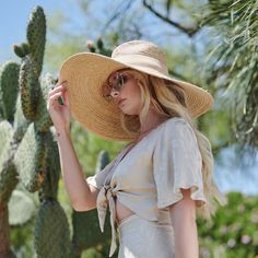 A true gem of a find! This Raffia style hat keeps you cool and out of the sun. Makes for a great go to when you head over to the beach or while reading by the pool. With an added touch of a faux suede band, this hat will be one of your favorites. Features: 6" Brim UPF 50+ Adjustable 100% Raffia Women's one size Faux Suede Band Raffia Braid Wide Brim Summer Fedora Panama Hat Made Of Palm Leaf, Wide Brim Summer Beach Hat, Summer Wide Brim Beach Hat, Adjustable Straw Hat For Poolside Beachwear, Beachy Sun Hat For The Beach, Beachy Sun Hat For Beach, Beachy Panama Hat With Uv Protection For Summer, Panama Hat With Uv Protection For Beach, Panama Hat With Upf 50+ For Beach Season