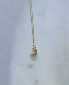 24k gold-plated crescent moon charm with zircon gems on a 14k gold-plated or 14k gold-filled chain. Necklaces are 16 inches in length with a 2 inch extender chain. Dainty Crescent Moon Charm Necklace, Everyday Crescent Necklace With Delicate Chain, Delicate Crescent Moon Charm Necklace, Dainty Necklace With Half Moon Charm, Dainty Half Moon Necklace With Moon Charm, Crescent Moon Charm Necklace, 14k Gold Crescent Celestial Necklace, Celestial Crescent 14k Gold Necklace, Everyday Half Moon Charm Necklace