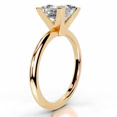 a yellow gold engagement ring with a princess cut diamond in the center, on a white background