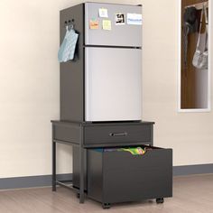 a refrigerator sitting on top of a filing cabinet